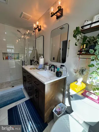 a bathroom with a sink double vanity and a mirror