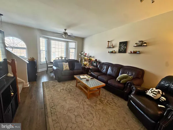 a living room with furniture rug and window