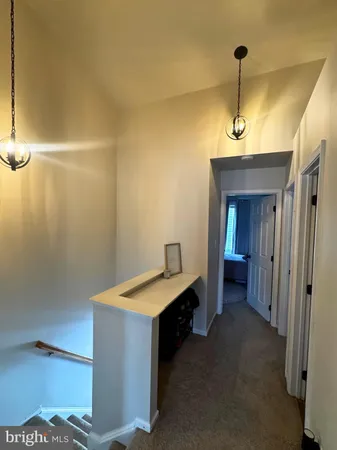 a room with bed and a chandelier