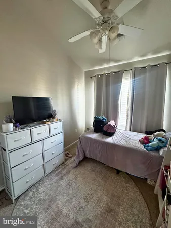 a bedroom with furniture and flat screen tv