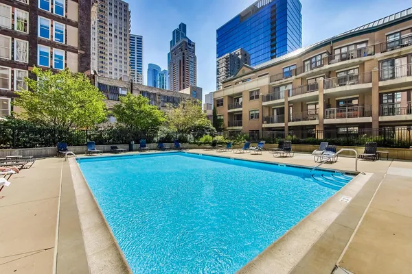 a swimming pool with outdoor seating and yard