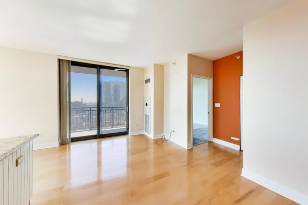 a view of an empty room with glass door