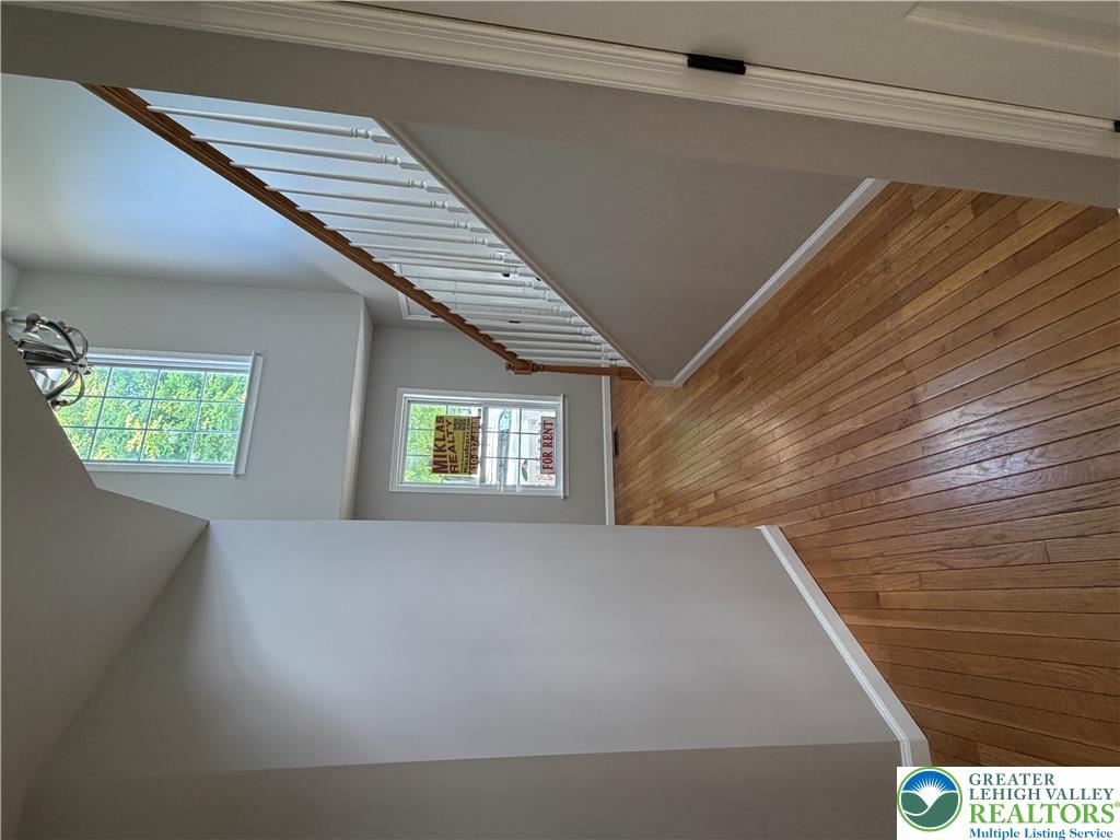 4157 Walter Road Bethlehem, PA 18020 - Photo 29 of 36 Natural light illuminates the rich hardwood floors and classic staircase leading to the upper level.
