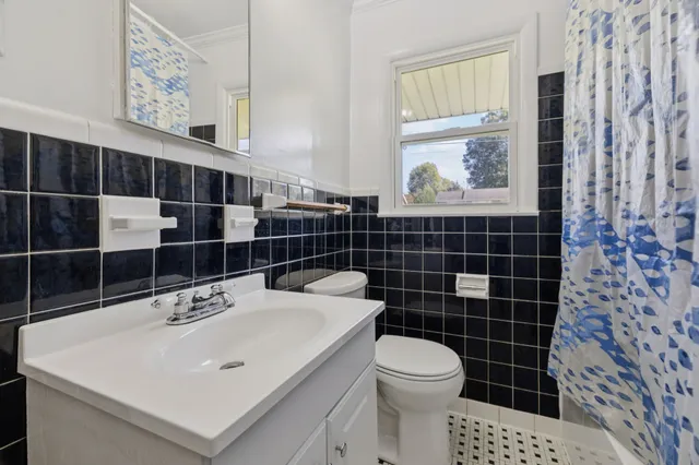 a view of an empty room with a fireplace and a window