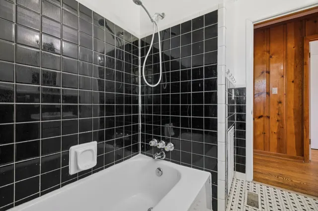 a view of empty room with wooden floor and fireplace