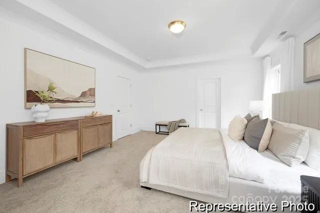 a bedroom with a bed and painting on the wall