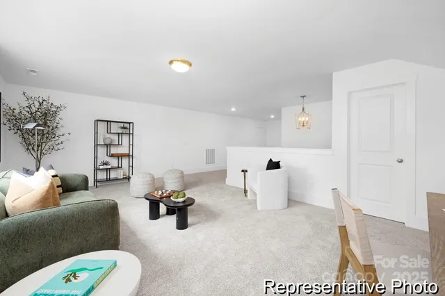 a living room with furniture and white walls