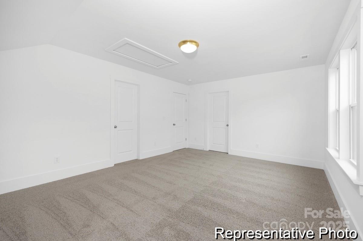 116 Soft Breeze Bend, Unit 163B Locust, NC 28097 - Photo 21 of 30 an empty room with a kitchen space and a window