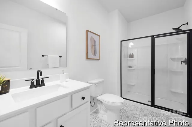 a bathroom with a sink toilet vanity and shower
