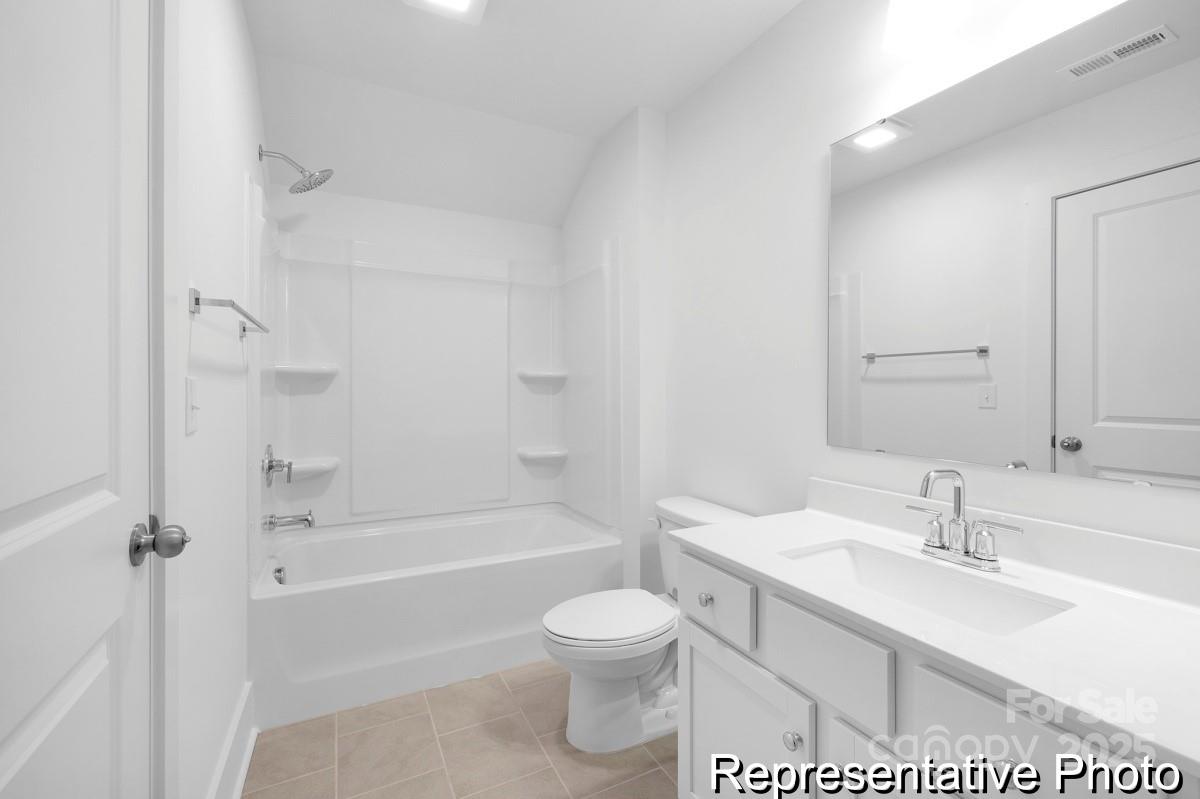 116 Soft Breeze Bend, Unit 163B Locust, NC 28097 - Photo 28 of 30 a bathroom with a sink toilet vanity and shower