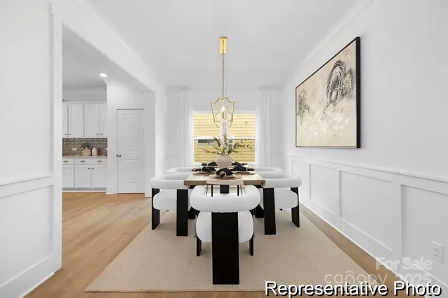 a dining room with furniture window and a chandelier