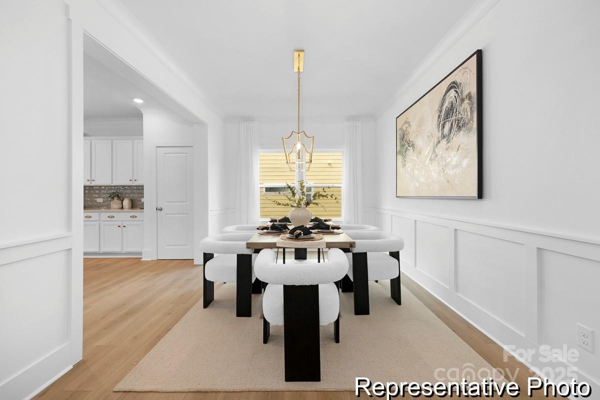116 Soft Breeze Bend, Unit 163B Locust, NC 28097 - Photo 5 of 30 a dining room with furniture window and a chandelier
