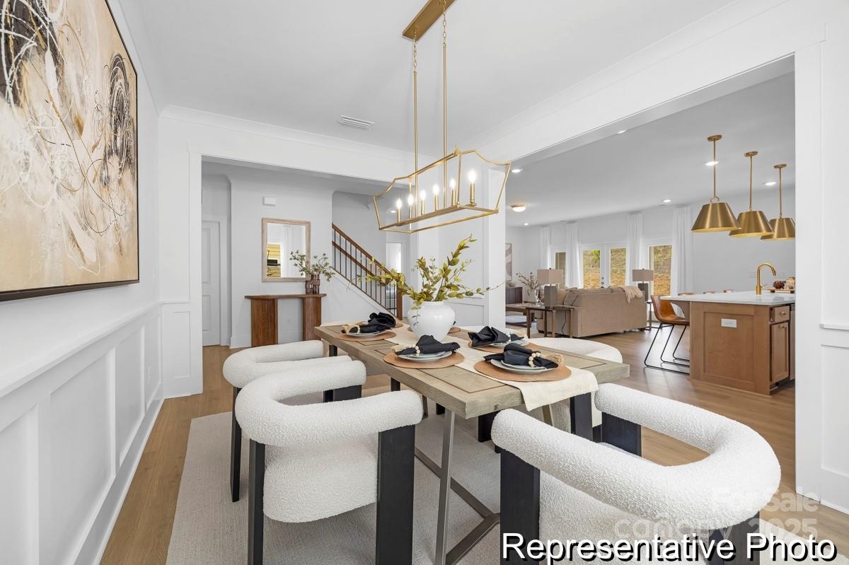 116 Soft Breeze Bend, Unit 163B Locust, NC 28097 - Photo 6 of 30 a living room with furniture and a chandelier