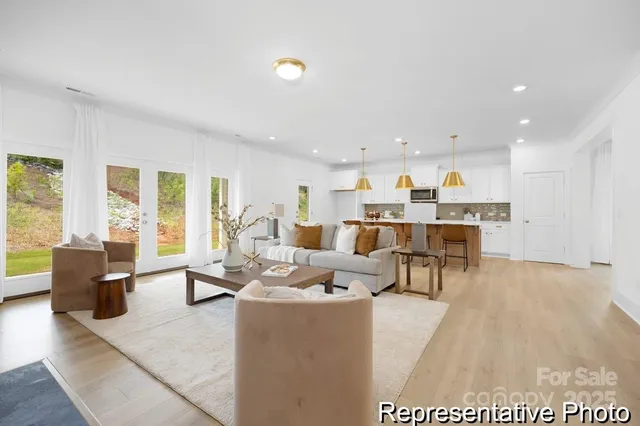 a living room with lots of furniture and kitchen view