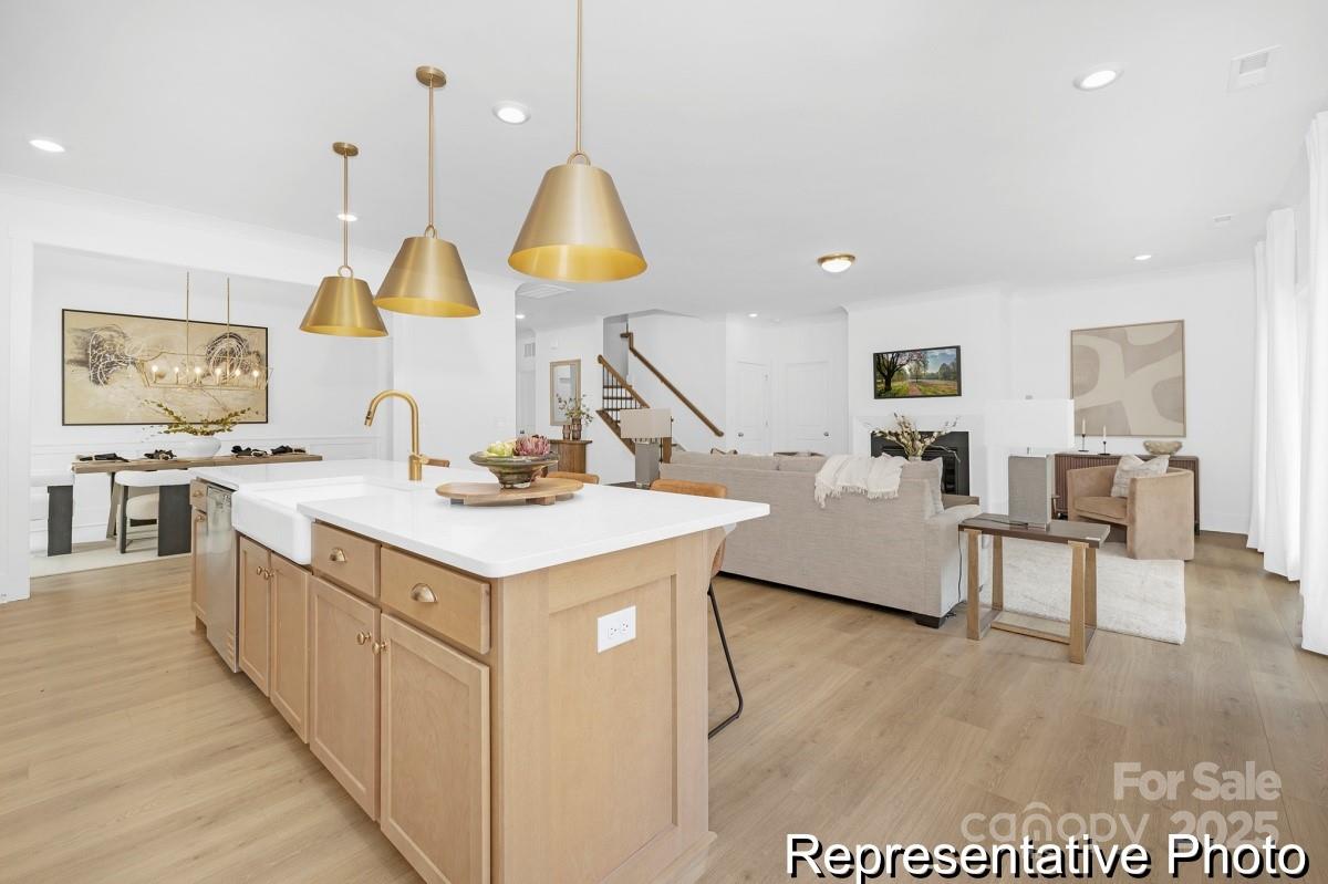 116 Soft Breeze Bend, Unit 163B Locust, NC 28097 - Photo 8 of 30 a kitchen with a sink a counter space and a view of living room
