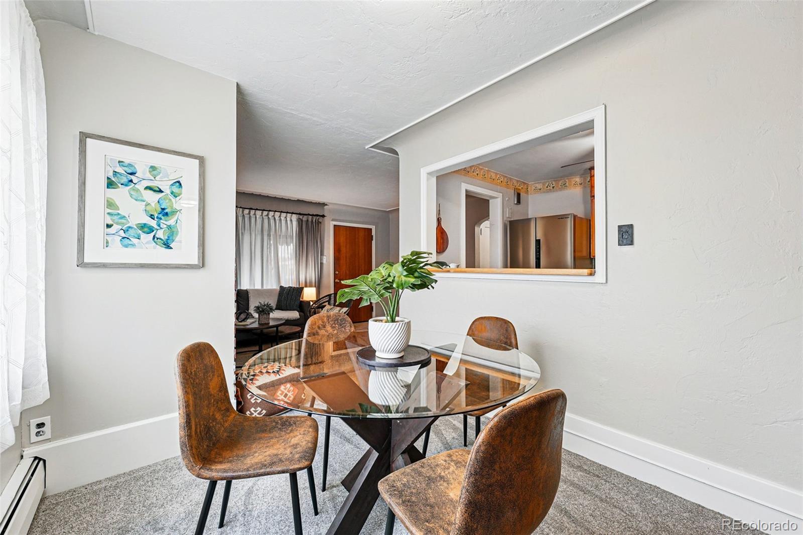500 South Decatur Street Denver, CO 80219 - Photo 12 of 46 a view of a dining room with furniture and a potted plant