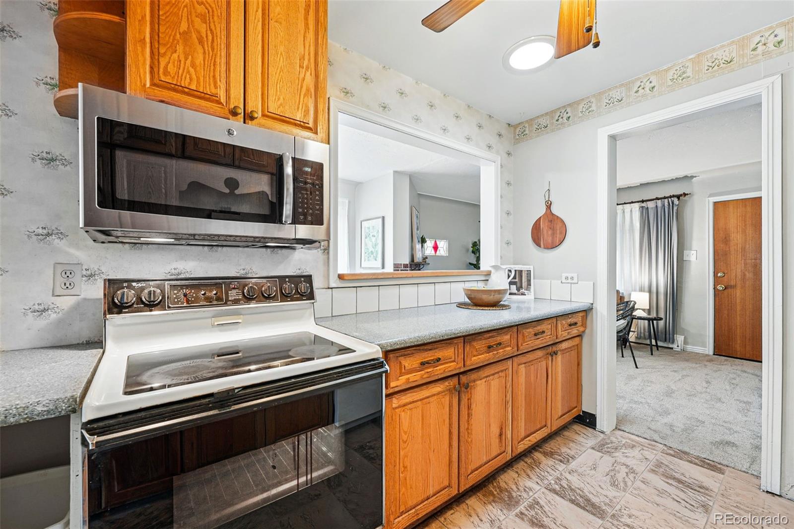 500 South Decatur Street Denver, CO 80219 - Photo 14 of 46 a kitchen with a stove and a microwave