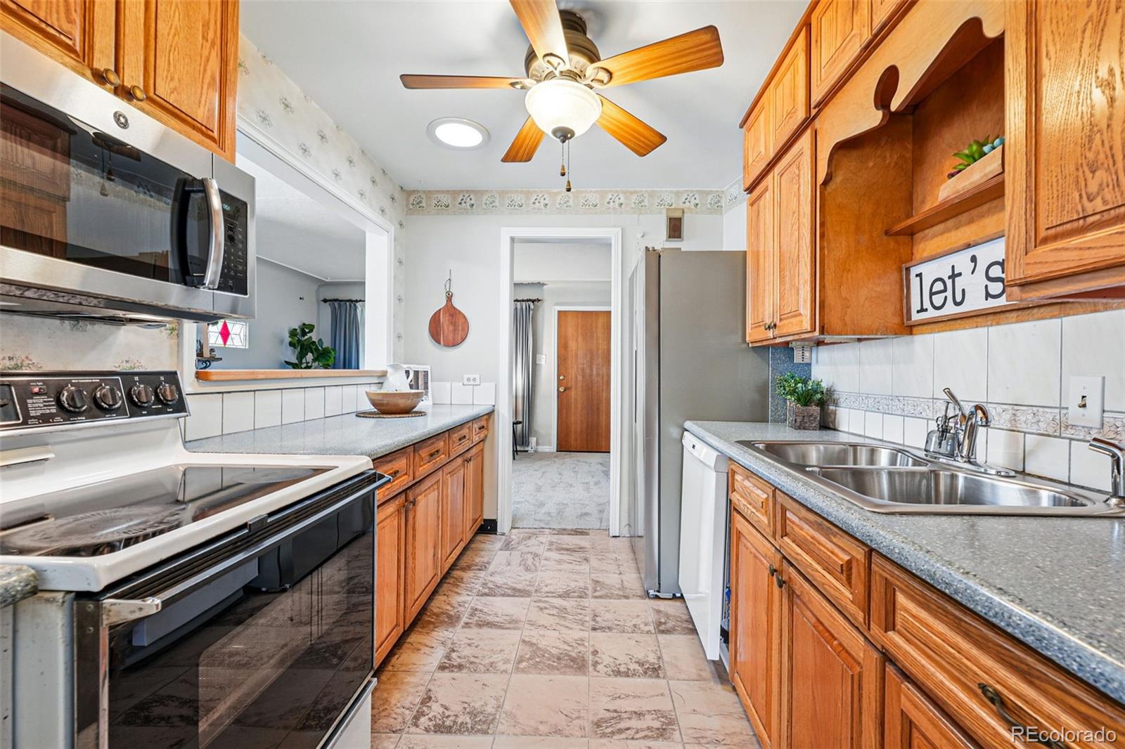 500 South Decatur Street Denver, CO 80219 - Photo 15 of 46 a kitchen with stainless steel appliances granite countertop a sink and a stove