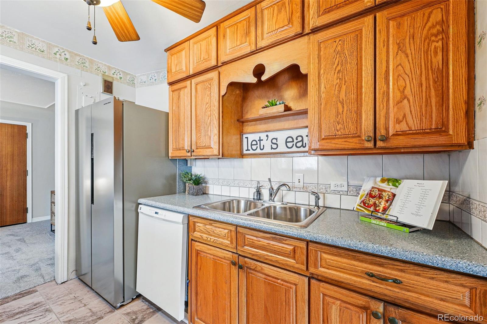 500 South Decatur Street Denver, CO 80219 - Photo 16 of 46 a kitchen with stainless steel appliances granite countertop a sink and refrigerator