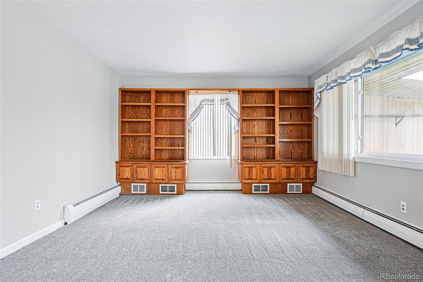 500 South Decatur Street Denver, CO 80219 - Photo 21 of 46 an empty room with a exposed radiator and closet