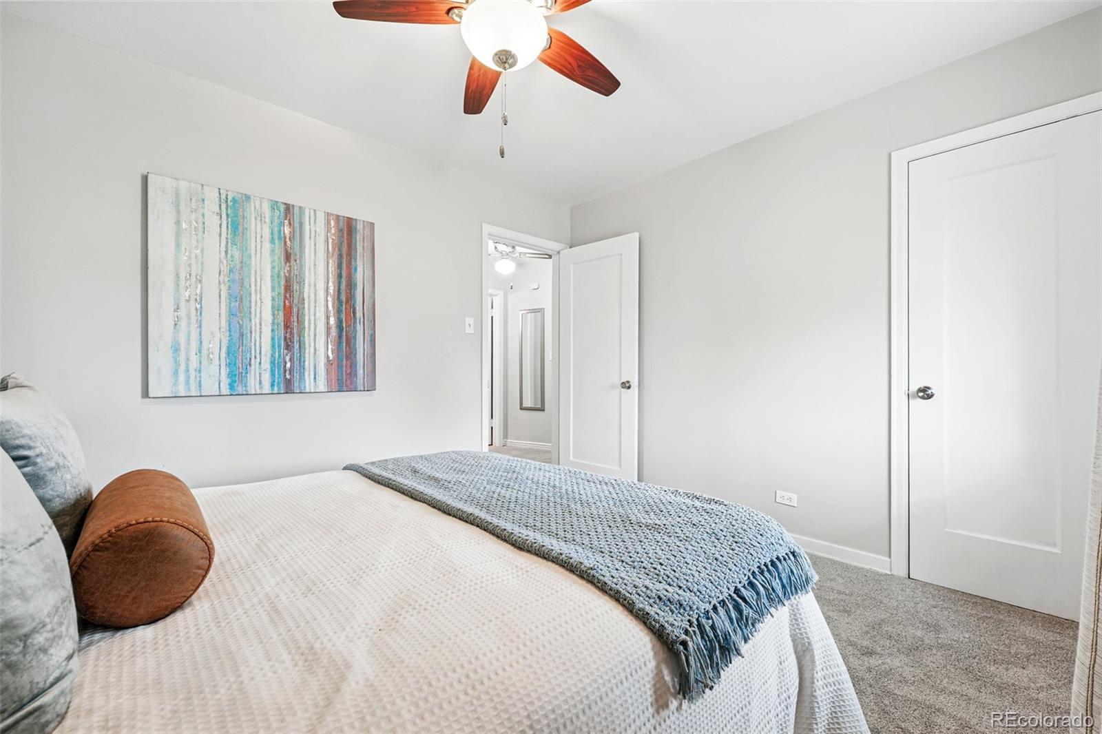 500 South Decatur Street Denver, CO 80219 - Photo 28 of 46 a bedroom with a bed and a painting on the wall
