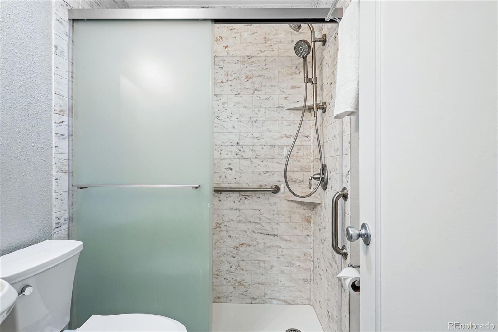 500 South Decatur Street Denver, CO 80219 - Photo 31 of 46 a bathroom with a shower and toilet