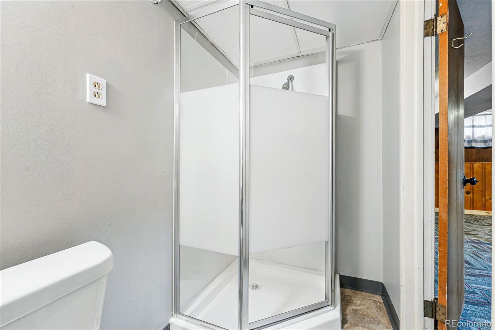 500 South Decatur Street Denver, CO 80219 - Photo 38 of 46 a bathroom with a shower and toilet