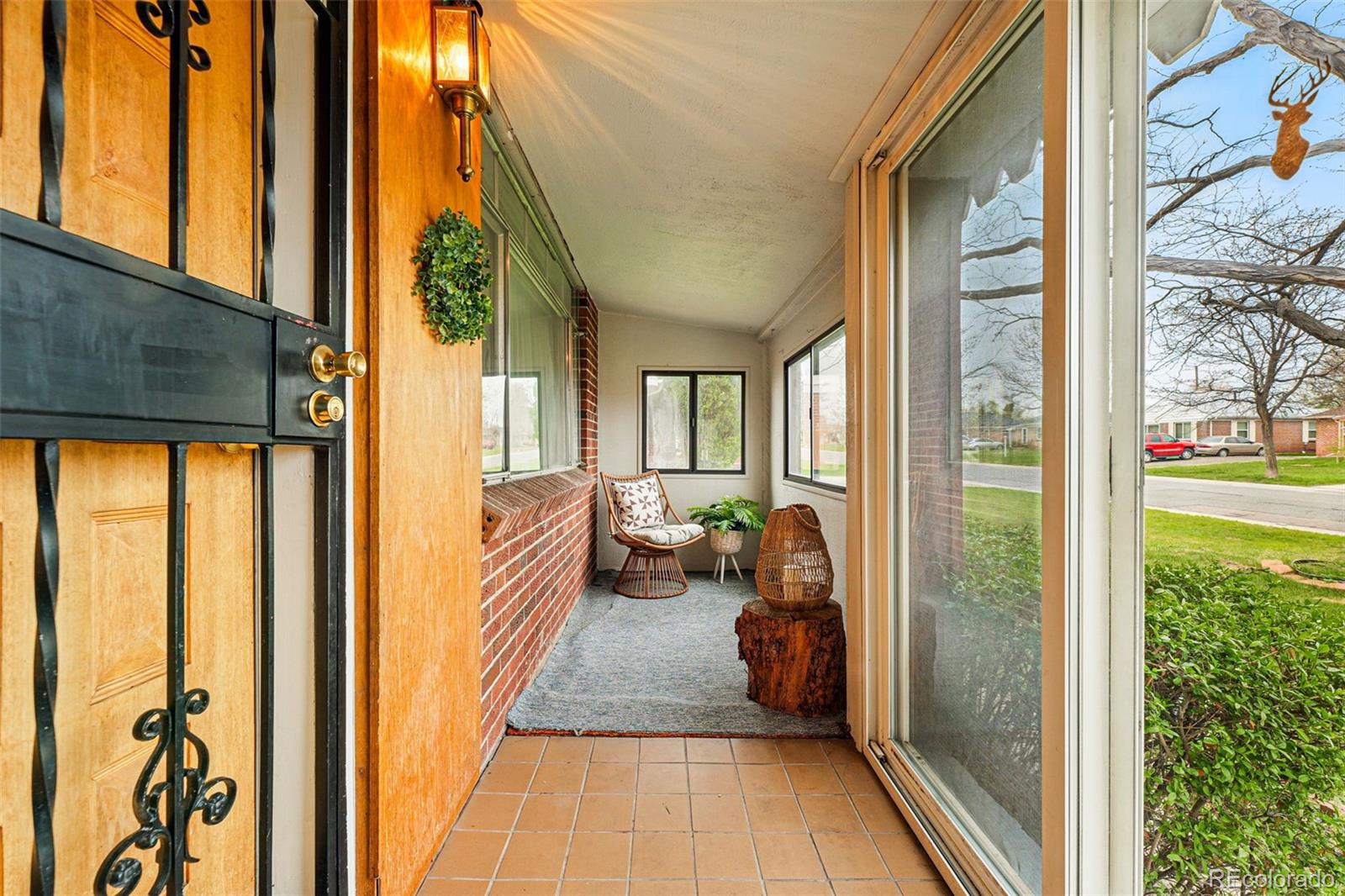 500 South Decatur Street Denver, CO 80219 - Photo 4 of 46 a view of a porch with furniture and floor to ceiling window