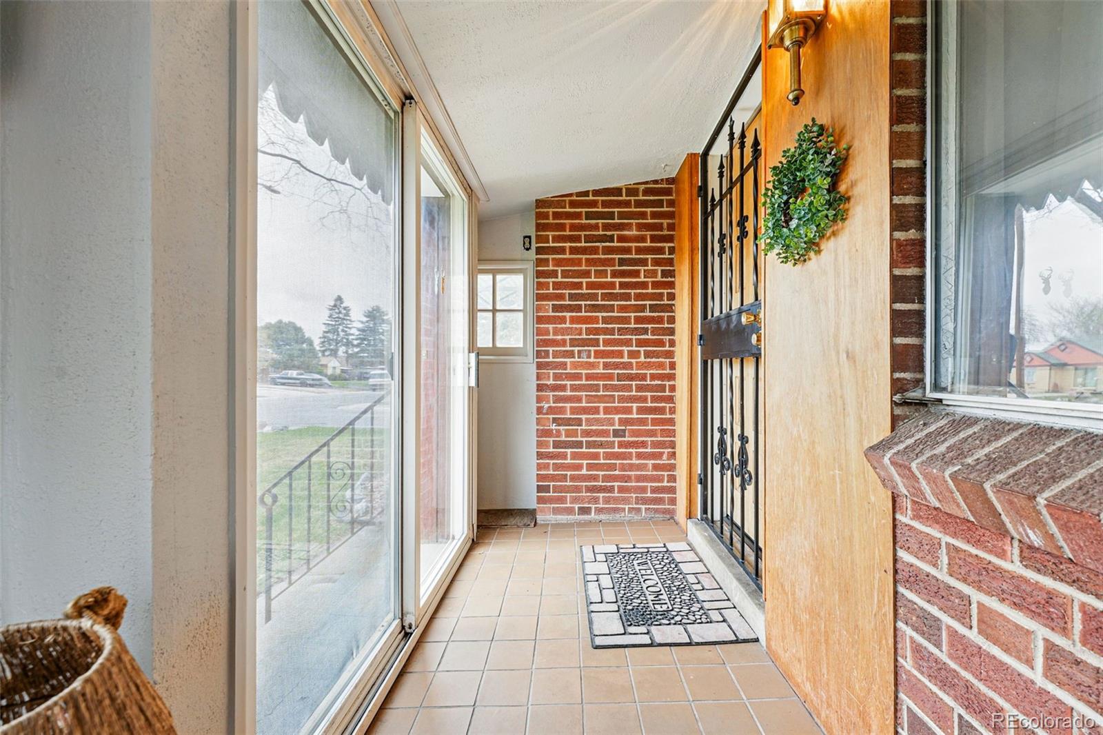 500 South Decatur Street Denver, CO 80219 - Photo 5 of 46 a view of a balcony with wooden floor and door
