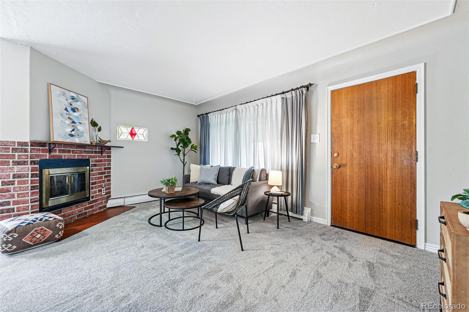 500 South Decatur Street Denver, CO 80219 - Photo 6 of 46 a living room with furniture a window and a fireplace