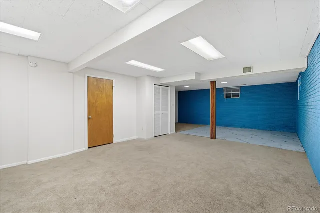 an empty room with a empty space and windows