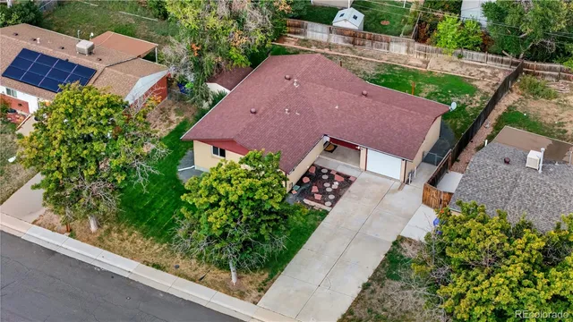 an aerial view of a house with garden space and street view