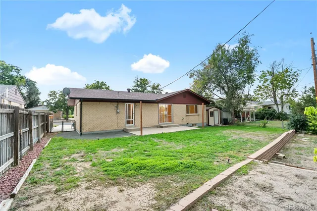 a backyard of a house with a tree