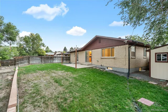 an aerial view of a house with a garden and trees all around
