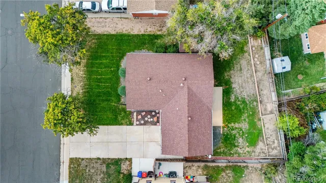 an aerial view of residential houses with outdoor space and trees