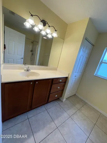 a room with a mirror and vanity