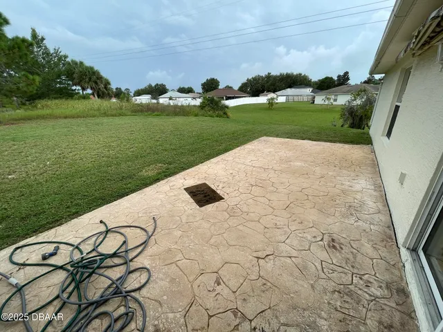 a view of a backyard with plants and lake