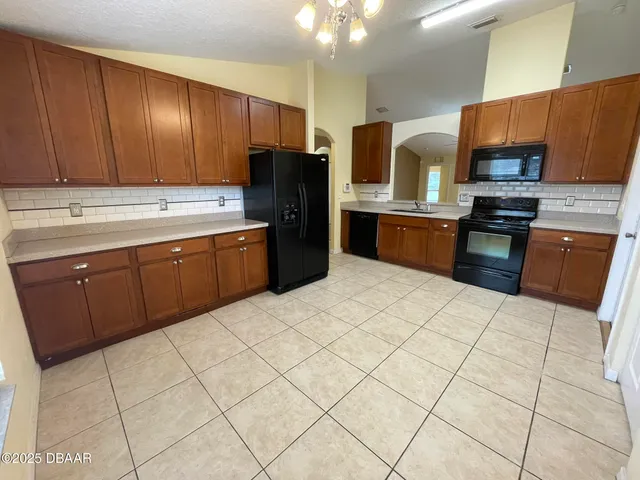 a kitchen with stainless steel appliances granite countertop a refrigerator sink and cabinets