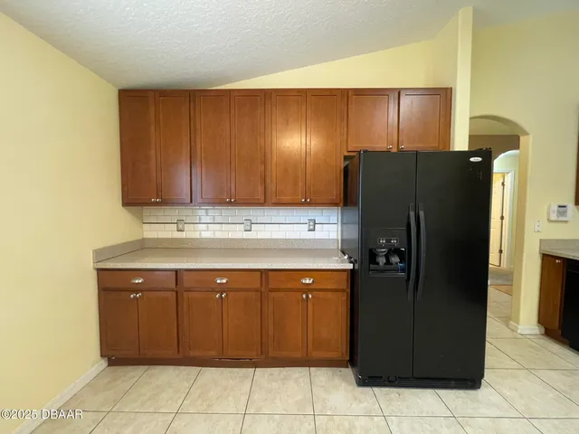 a kitchen with a refrigerator and a cabinets