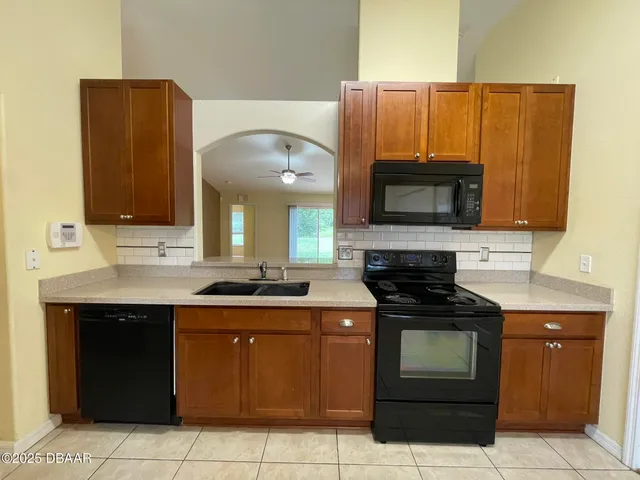 a kitchen with a sink and a stove top oven
