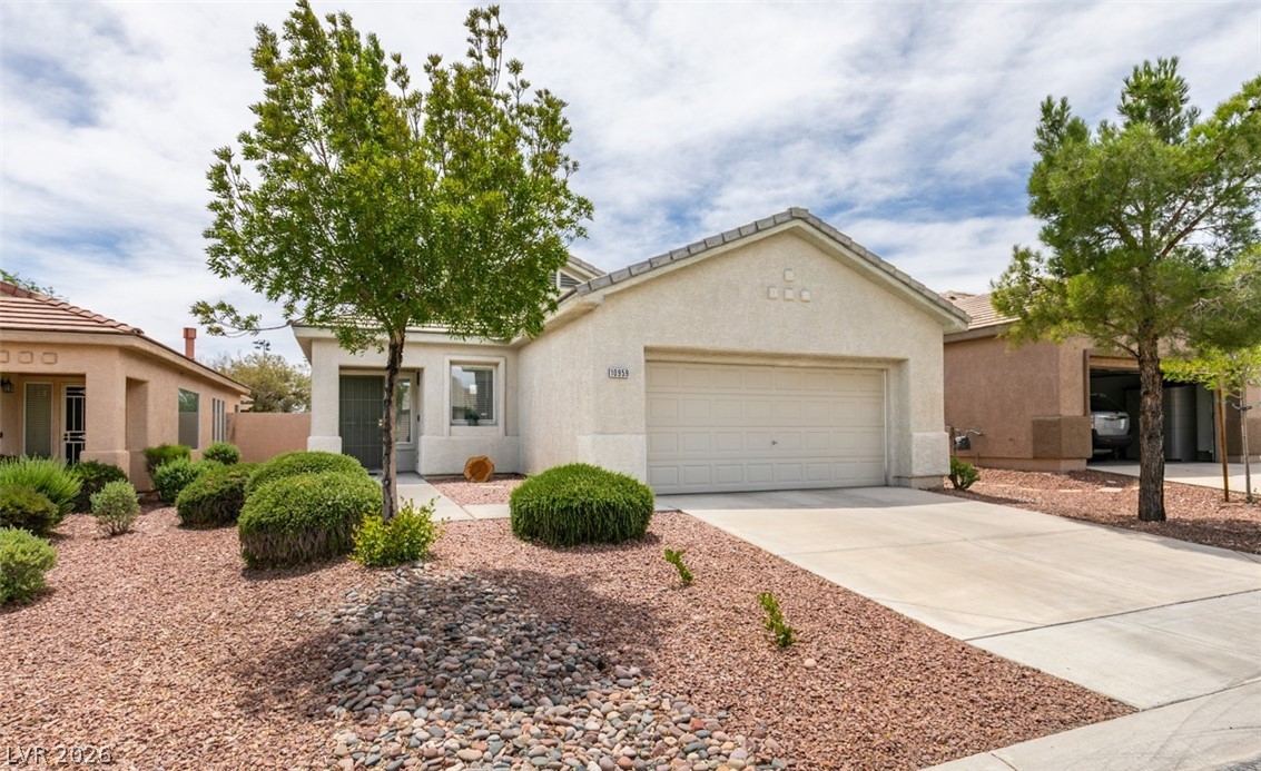 10959 Pumpkin Ridge Avenue Las Vegas, NV 89135 - Photo 38 of 51 A well-maintained concrete driveway leads to this charming single-story residence with desert landscaping in the heart of Summerlin.