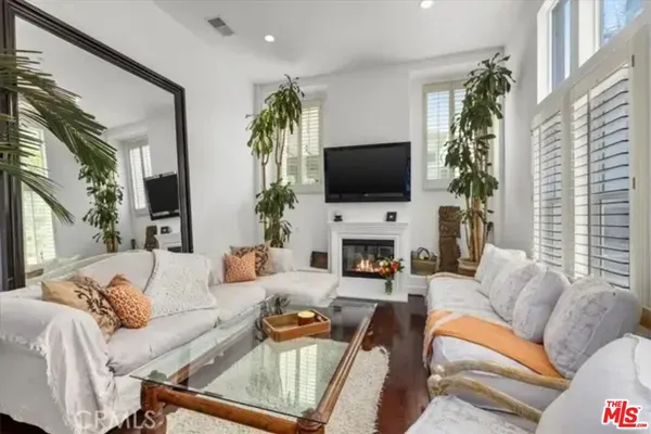 a living room with furniture a fireplace and a flat screen tv