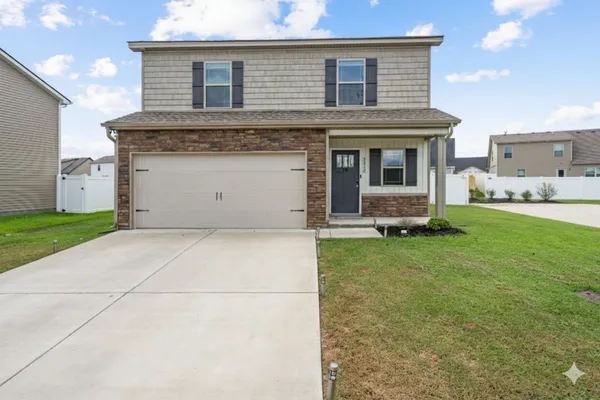 a front view of a house with a yard