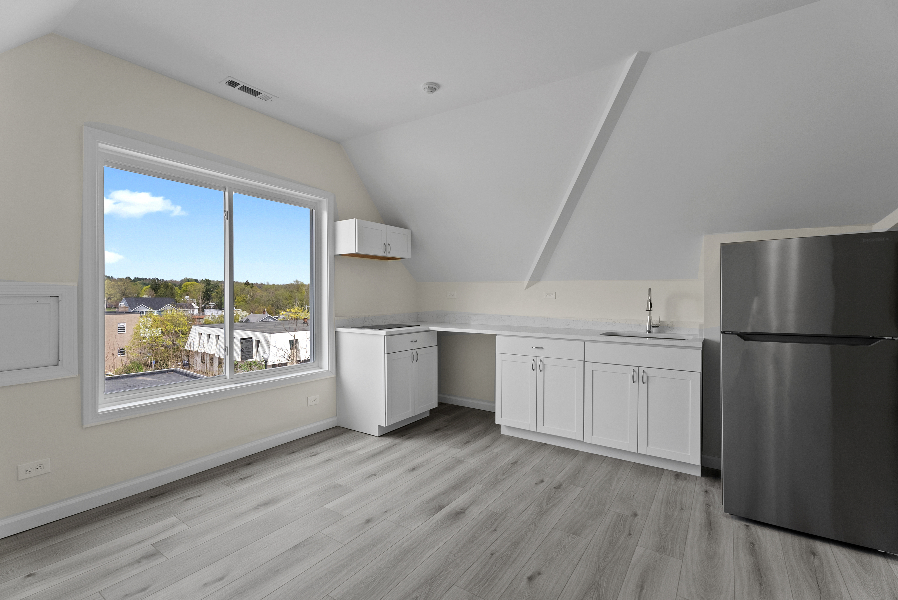 72 South Main Street, Unit 3B Wallingford, CT 06492 - Photo 1 of 8 a kitchen with a refrigerator a sink and dishwasher with wooden floor