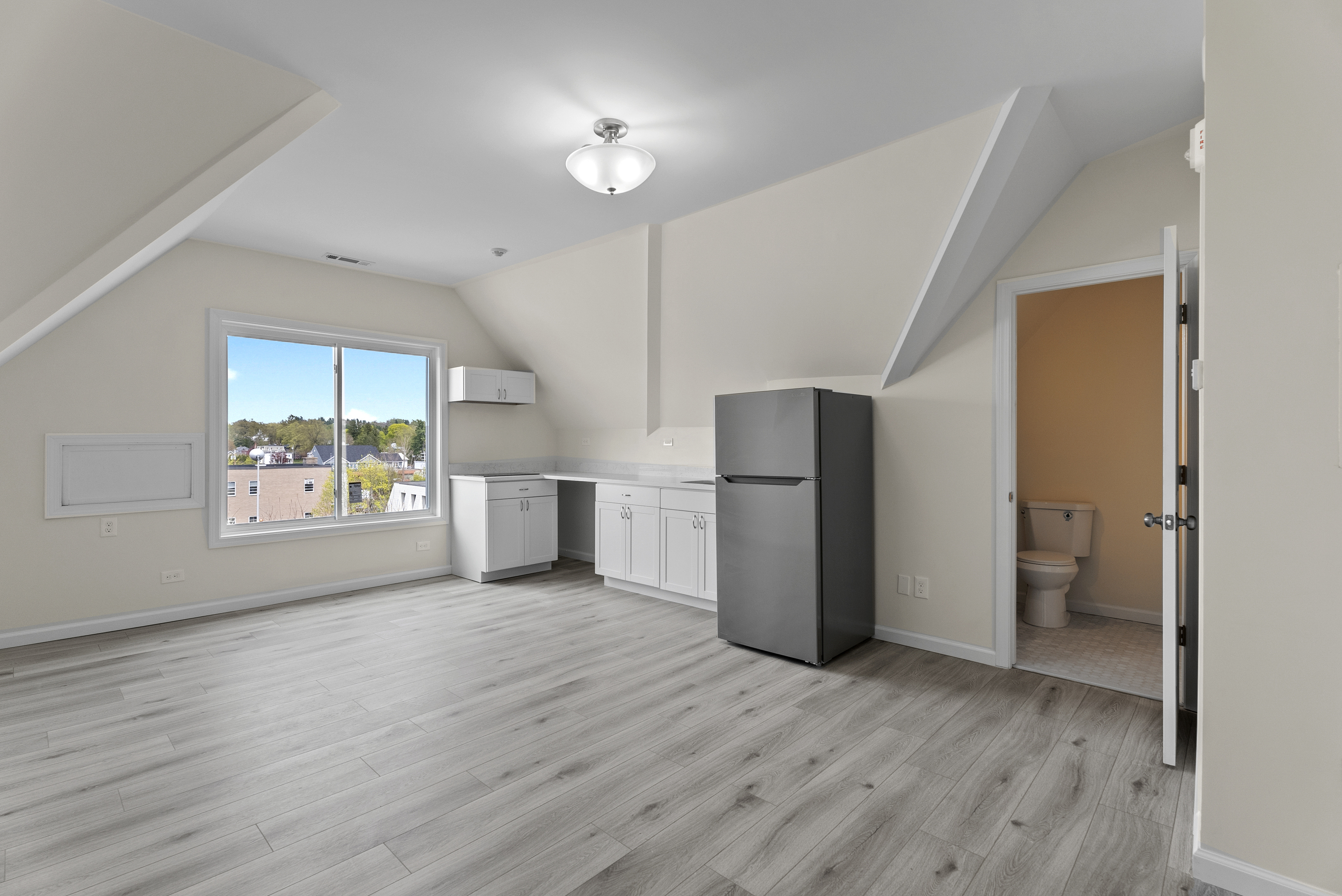 72 South Main Street, Unit 3B Wallingford, CT 06492 - Photo 2 of 8 a view of hallway with wooden floor and a refrigerator