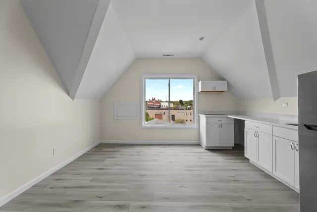 a view of a kitchen with a dishwasher and wooden floor