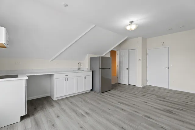 a view of a kitchen with wooden floor