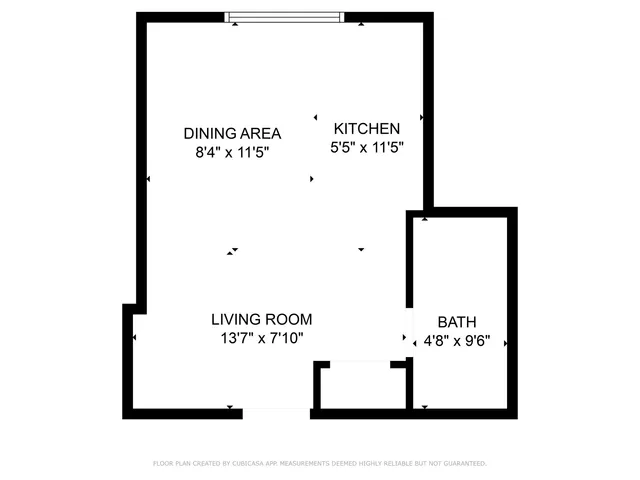 a picture of a building with a white fence