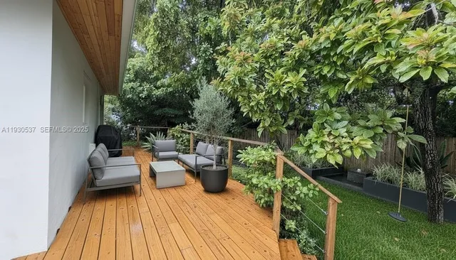 a balcony with wooden floor and outdoor seating