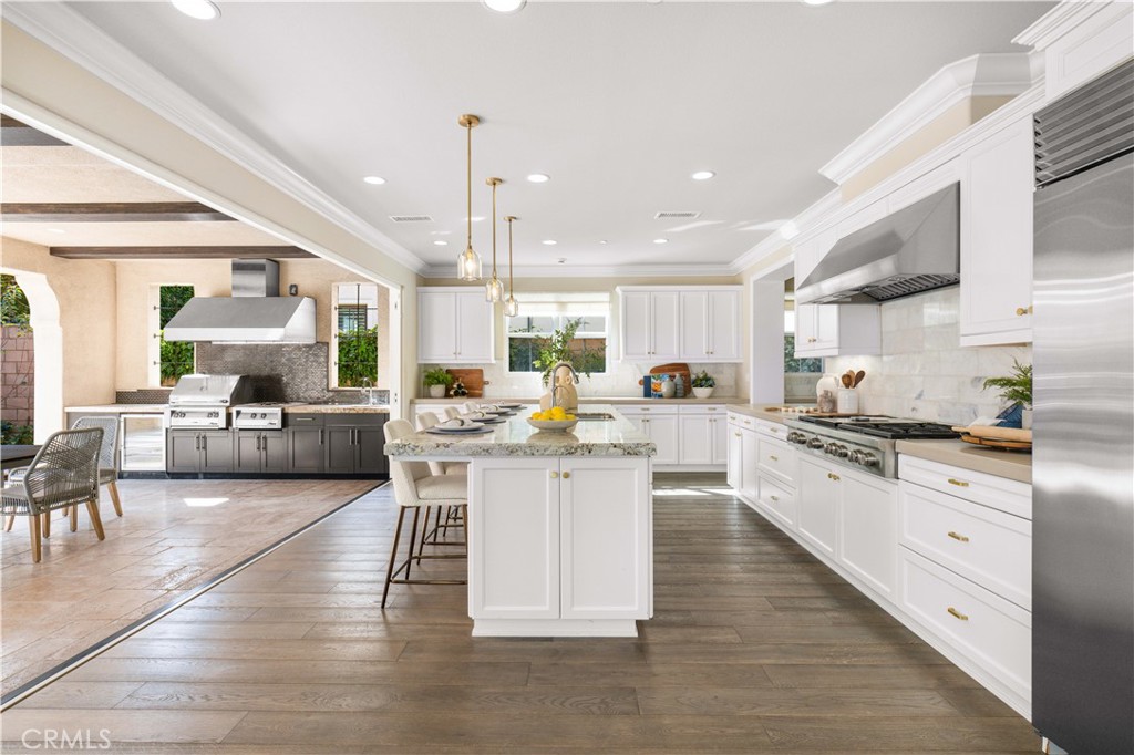 71 Clocktower Irvine, CA 92620 - Photo 11 of 73 Fully retractable bi-fold glass doors connect the kitchen seamlessly to the California room